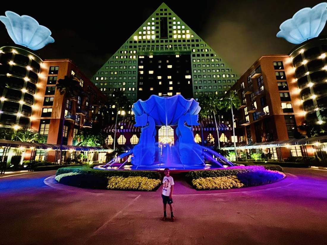 The Dolphin fountain lit up at night.